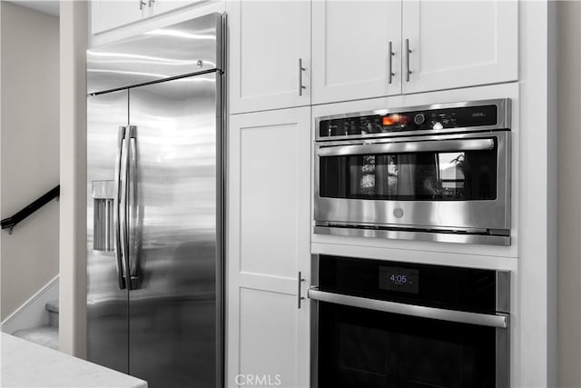 10 Veraz Rd, Rancho Mission Viejo, CA 92694 - kitchen featuring appliances with stainless steel finishes, white cabinetry, and light stone counters