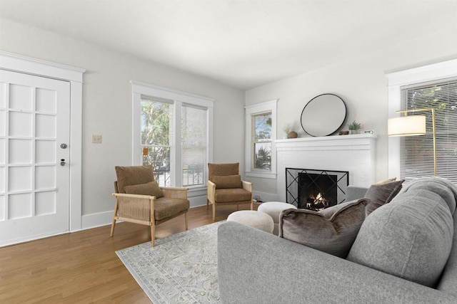 3536 Park Villa, San Diego, CA 92104 - living area with a warm lit fireplace, wood finished floors, and baseboards
