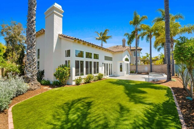 1736 Blackbird Cir, Carlsbad, CA 92011 - rear view of house with stucco siding, a chimney, a tile roof, and a patio