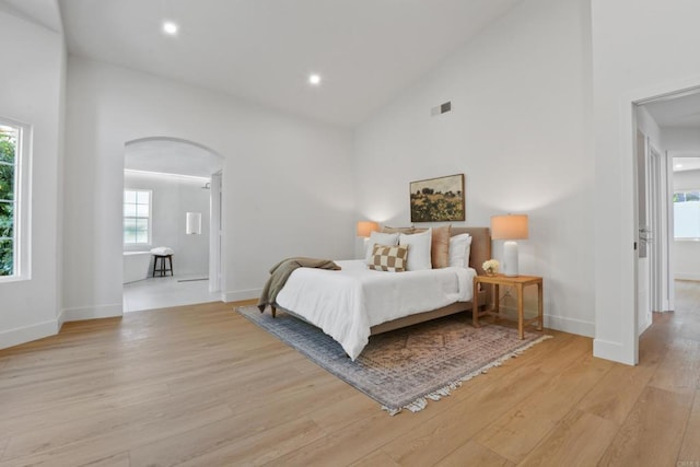 1736 Blackbird Cir, Carlsbad, CA 92011 - bedroom with arched walkways, light wood finished floors, high vaulted ceiling, baseboards, and recessed lighting