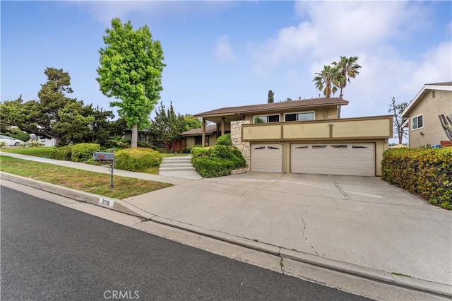 2116 Via Caliente, Fullerton, CA 92833 - view of front of home featuring stone siding, concrete driveway, and stucco siding