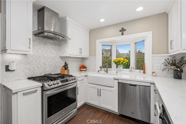 9 Northgrove Unit 11, Irvine, CA 92604 - kitchen featuring appliances with stainless steel finishes, wall chimney range hood, white cabinetry, and recessed lighting