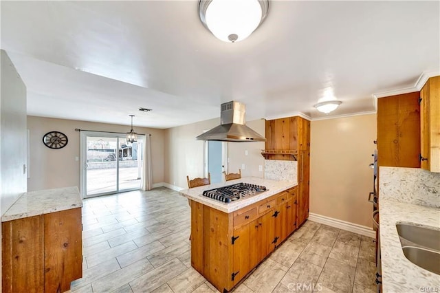 5306 W W Ave M4, Lancaster, CA 93536 - kitchen featuring stainless steel gas stovetop, extractor fan, a peninsula, brown cabinets, and backsplash