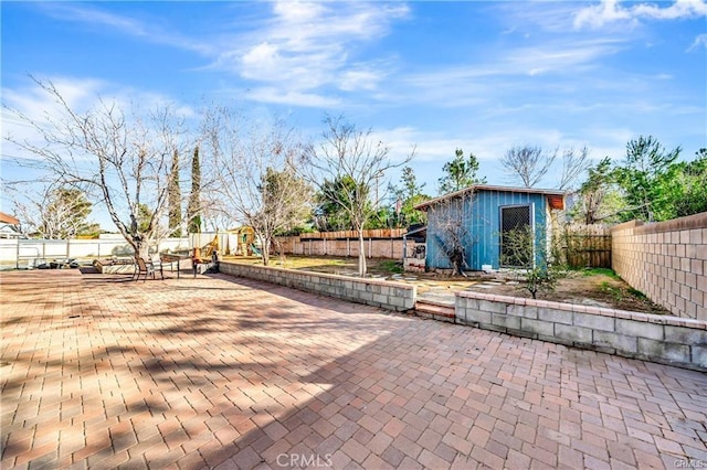 5306 W W Ave M4, Lancaster, CA 93536 - view of community with a fenced backyard, a patio area, a storage shed, and an outdoor structure
