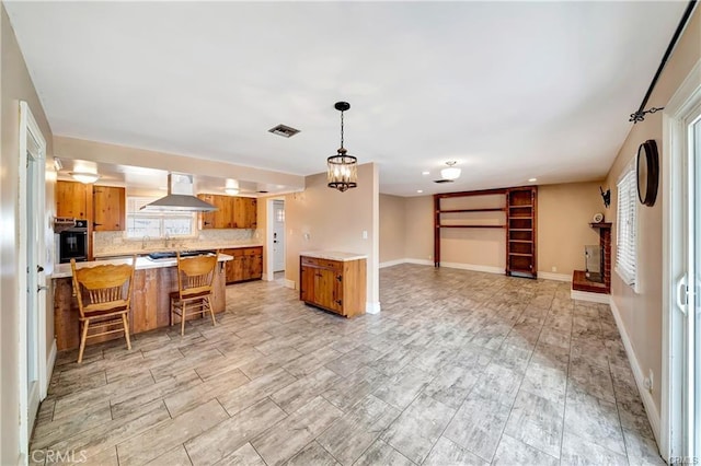 5306 W W Ave M4, Lancaster, CA 93536 - kitchen featuring extractor fan, brown cabinetry, open floor plan, light countertops, and oven