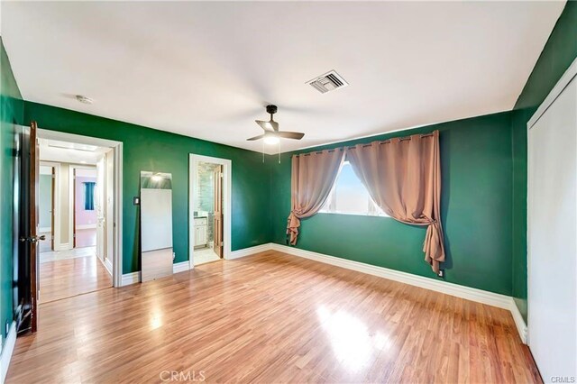 5306 W W Ave M4, Lancaster, CA 93536 - unfurnished bedroom with baseboards, wood finished floors, and connected bathroom