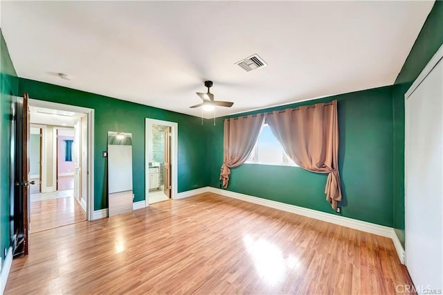 5306 W W Ave M4, Lancaster, CA 93536 - unfurnished bedroom featuring wood finished floors, a ceiling fan, and connected bathroom