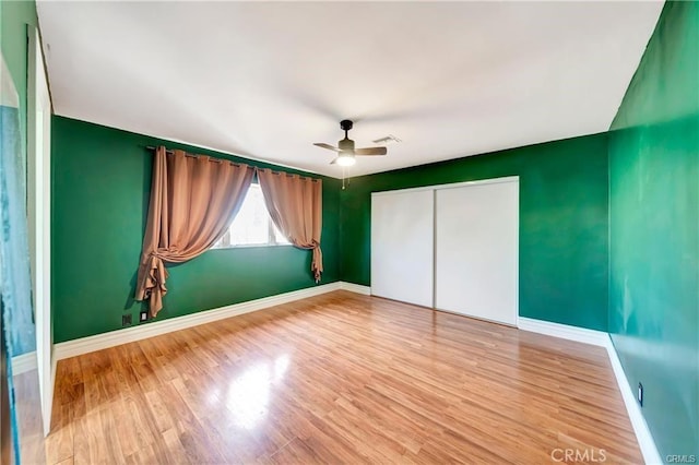 5306 W W Ave M4, Lancaster, CA 93536 - unfurnished bedroom featuring a closet, baseboards, and light wood finished floors