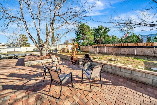 5306 W W Ave M4, Lancaster, CA 93536 - view of patio / terrace with a fenced backyard and a playground