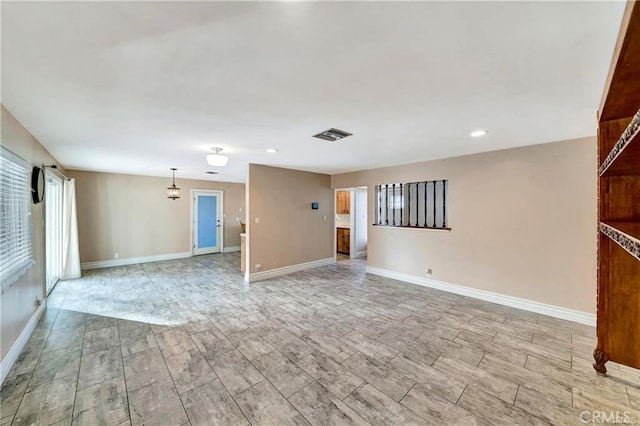 5306 W W Ave M4, Lancaster, CA 93536 - unfurnished living room featuring baseboards, wood tiled floors, and recessed lighting