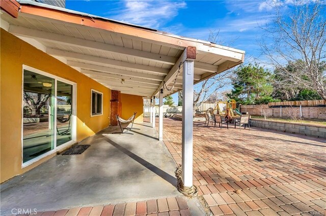 5306 W W Ave M4, Lancaster, CA 93536 - view of patio / terrace featuring a playground and fence