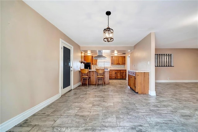 5306 W W Ave M4, Lancaster, CA 93536 - kitchen featuring brown cabinets, wall chimney exhaust hood, a peninsula, and light countertops