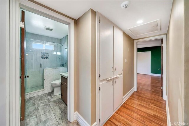 5306 W W Ave M4, Lancaster, CA 93536 - corridor featuring attic access, baseboards, and light wood-style flooring