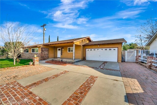 5306 W W Ave M4, Lancaster, CA 93536 - ranch-style house featuring stucco siding, driveway, fence, and an attached garage