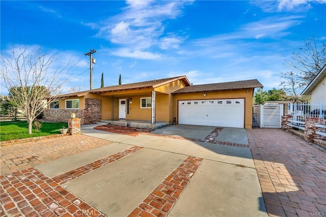 5306 W W Ave M4, Lancaster, CA 93536 - ranch-style house featuring stucco siding, driveway, and a garage