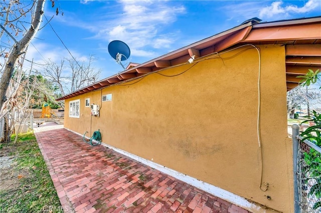 5306 W W Ave M4, Lancaster, CA 93536 - view of side of home with fence, stucco siding, and a patio