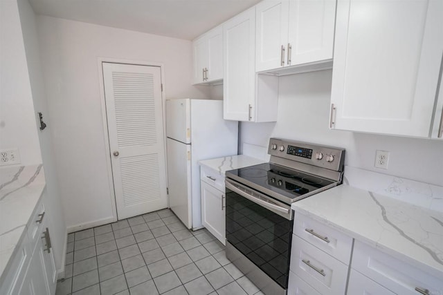 6860 Panamint Row Unit 2, San Diego, CA 92139 - kitchen featuring stainless steel electric range, freestanding refrigerator, white cabinetry, light tile patterned floors, and light stone counters