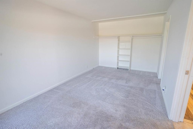 6860 Panamint Row Unit 2, San Diego, CA 92139 - unfurnished bedroom featuring light colored carpet, a closet, and baseboards