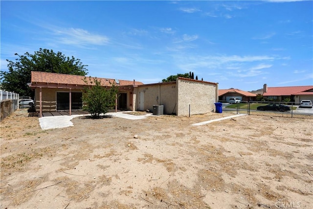 14889 Hartford Ln, Helendale, CA 92342 - rear view of house featuring stucco siding, fence, and central air condition unit