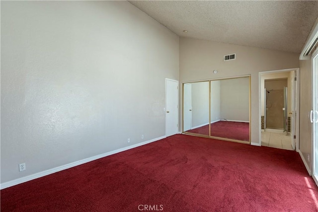 14889 Hartford Ln, Helendale, CA 92342 - unfurnished bedroom featuring lofted ceiling, carpet flooring, a textured ceiling, baseboards, and a closet