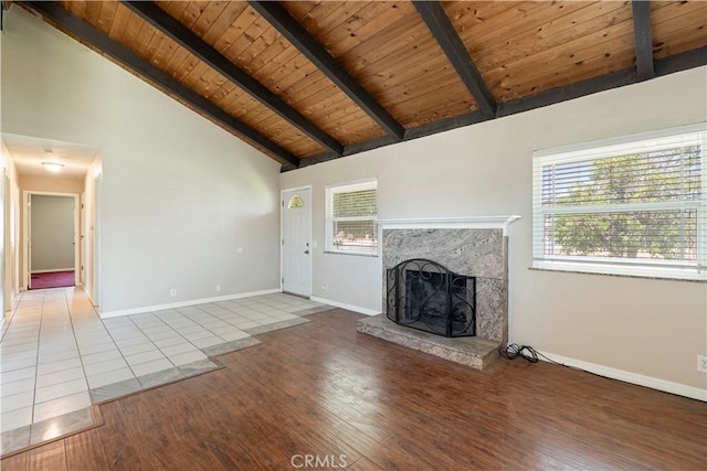 14889 Hartford Ln, Helendale, CA 92342 - unfurnished living room with a high end fireplace, wooden ceiling, tile patterned floors, beam ceiling, and baseboards