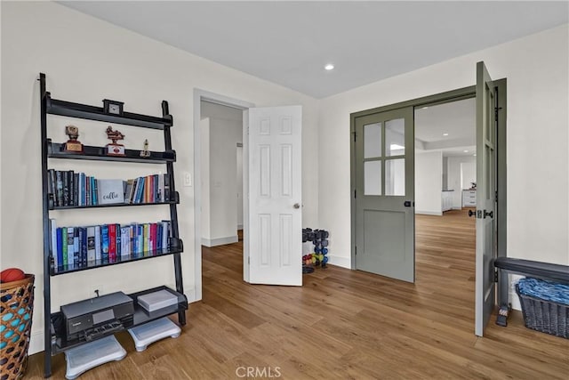 bedroom with wood finished floors, baseboards, and recessed lighting