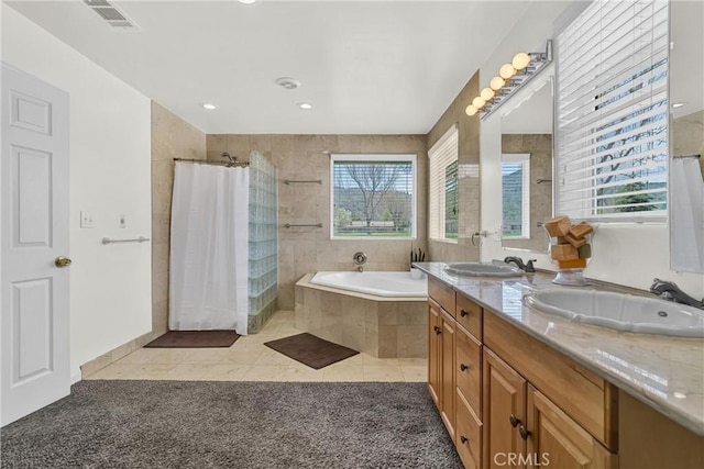full bathroom featuring a garden tub, tiled shower, tile patterned floors, double vanity, and recessed lighting