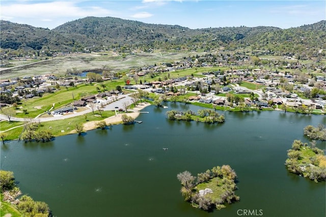 aerial view of property and surrounding area with nearby suburban area and a water and mountain view