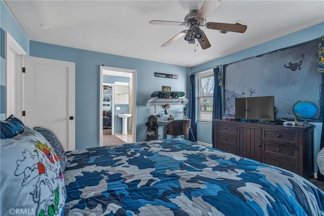 carpeted bedroom with ceiling fan and ensuite bath