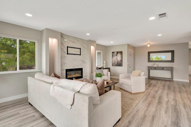 1055 Via Lomita, Escondido, CA 92027 - living area with healthy amount of natural light, recessed lighting, a high end fireplace, baseboards, and light wood-style flooring