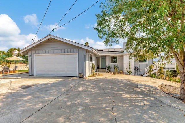 1055 Via Lomita, Escondido, CA 92027 - single story home featuring driveway, board and batten siding, solar panels, and an attached garage