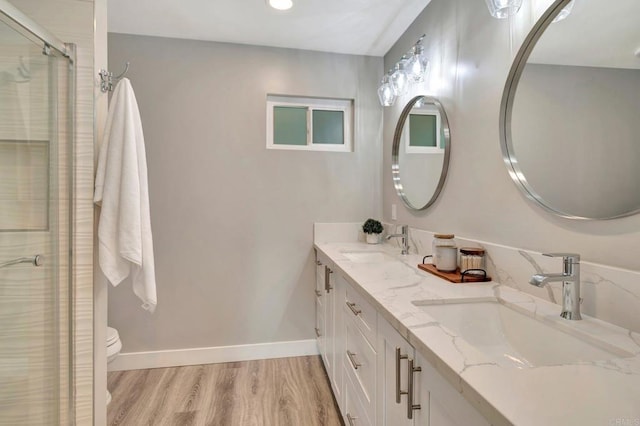 1055 Via Lomita, Escondido, CA 92027 - bathroom with wood finished floors, a shower stall, double vanity, baseboards, and recessed lighting