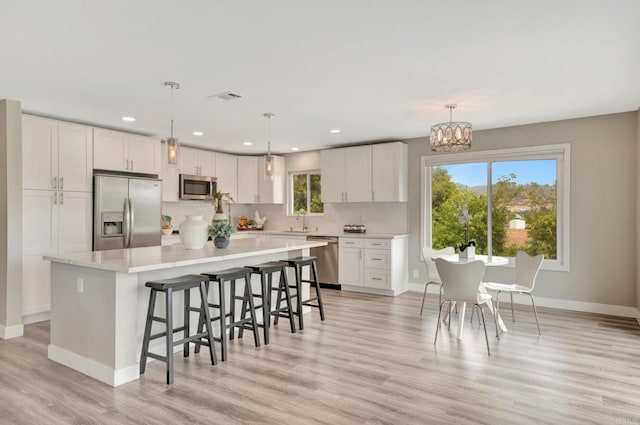 1055 Via Lomita, Escondido, CA 92027 - kitchen featuring stainless steel appliances, a sink, light countertops, white cabinetry, and a kitchen island
