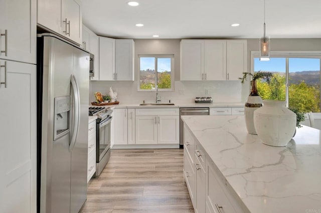 1055 Via Lomita, Escondido, CA 92027 - kitchen with appliances with stainless steel finishes, a sink, plenty of natural light, white cabinetry, and recessed lighting