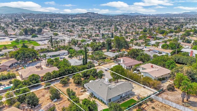 1055 Via Lomita, Escondido, CA 92027 - aerial view of residential area with mountains and property parcel outlined