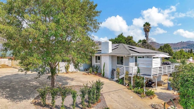 1055 Via Lomita, Escondido, CA 92027 - view of front of property featuring solar panels, a chimney, and a mountain view
