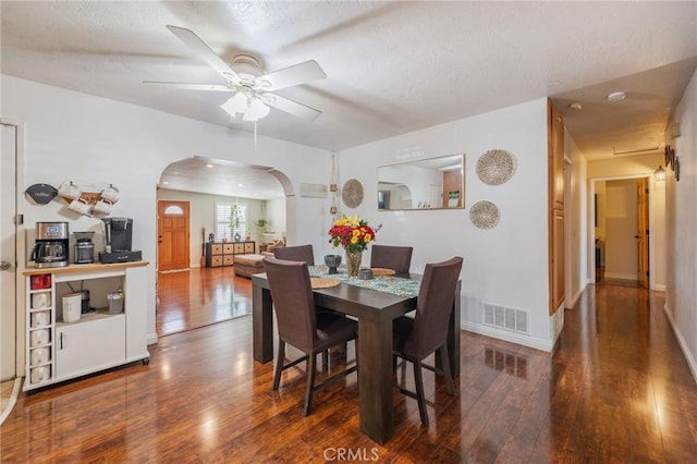 2219 S Elderberry Ave, Ontario, CA 91762 - dining room featuring arched walkways, hardwood / wood-style flooring, a ceiling fan, a textured ceiling, and baseboards