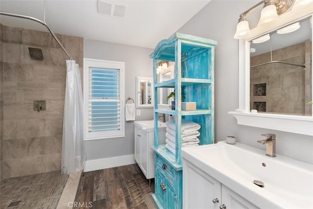 620 Via Umbroso, San Clemente, CA 92672 - bathroom with tiled shower, vanity, wood finished floors, and baseboards