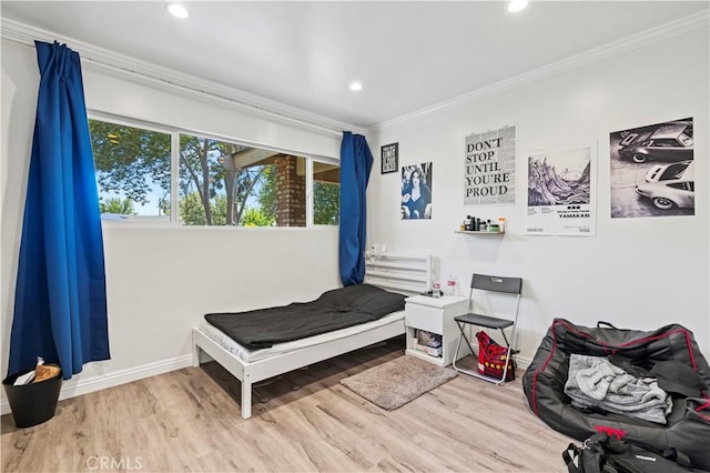 bedroom with wood finished floors, ornamental molding, and recessed lighting