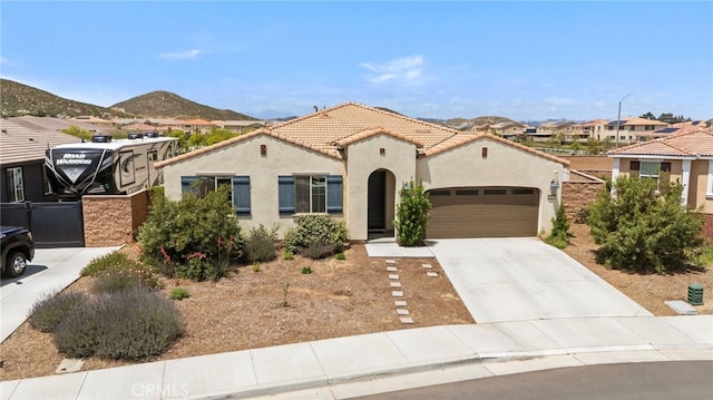 27083 Comrade Cir, Menifee, CA 92585 - mediterranean / spanish home featuring stucco siding, a garage, concrete driveway, a mountain view, and a residential view