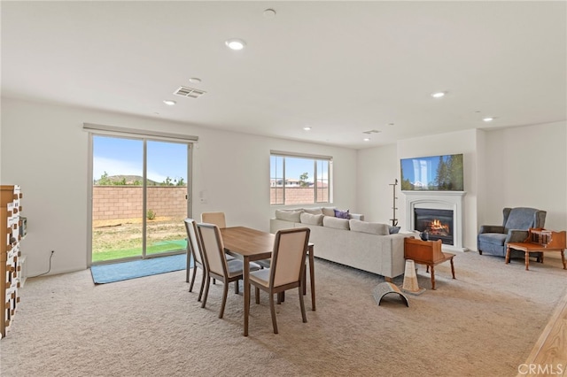 27083 Comrade Cir, Menifee, CA 92585 - dining area featuring carpet flooring, a glass covered fireplace, and recessed lighting