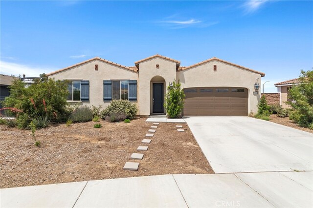 27083 Comrade Cir, Menifee, CA 92585 - mediterranean / spanish home with stucco siding, concrete driveway, an attached garage, and a tile roof