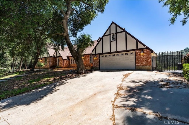 37095 Oak View Rd, Yucaipa, CA 92399 - english style home featuring concrete driveway, a garage, brick siding, and a gate