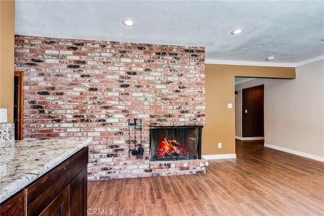 37095 Oak View Rd, Yucaipa, CA 92399 - unfurnished living room featuring baseboards, crown molding, a brick fireplace, wood finished floors, and recessed lighting