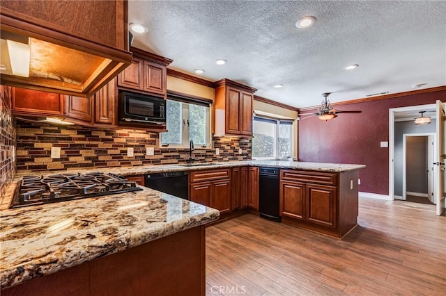 37095 Oak View Rd, Yucaipa, CA 92399 - kitchen with black appliances, a sink, a textured ceiling, a peninsula, and tasteful backsplash