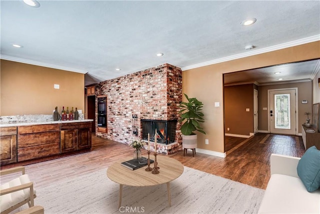 37095 Oak View Rd, Yucaipa, CA 92399 - living area featuring light wood-type flooring, crown molding, a brick fireplace, baseboards, and recessed lighting