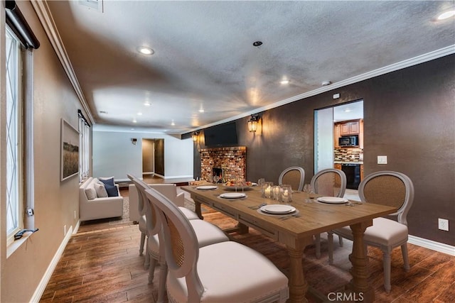 37095 Oak View Rd, Yucaipa, CA 92399 - dining area featuring wood finished floors, baseboards, recessed lighting, crown molding, and a fireplace