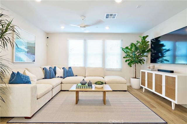 living room with a ceiling fan, wood finished floors, and recessed lighting