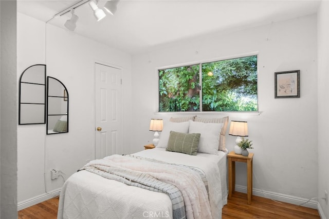 5375 Nord Hwy, Chico, CA 95973 - bedroom with rail lighting, wood finished floors, and baseboards