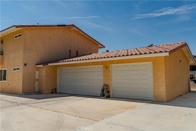 garage featuring concrete driveway